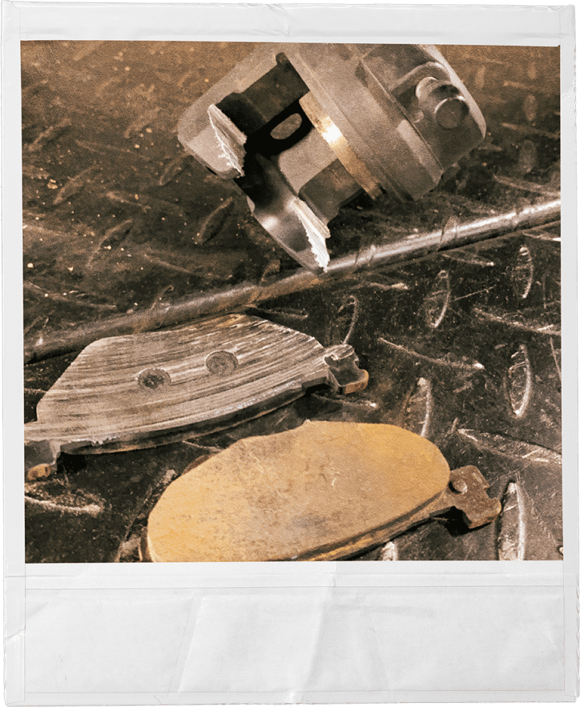 Motorcycle brake pads being installed by Twisting Steel, the go-to place for off-warranty motorcycle parts in Edmonton.